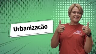 Professora ao lado do texto"Urbanização".