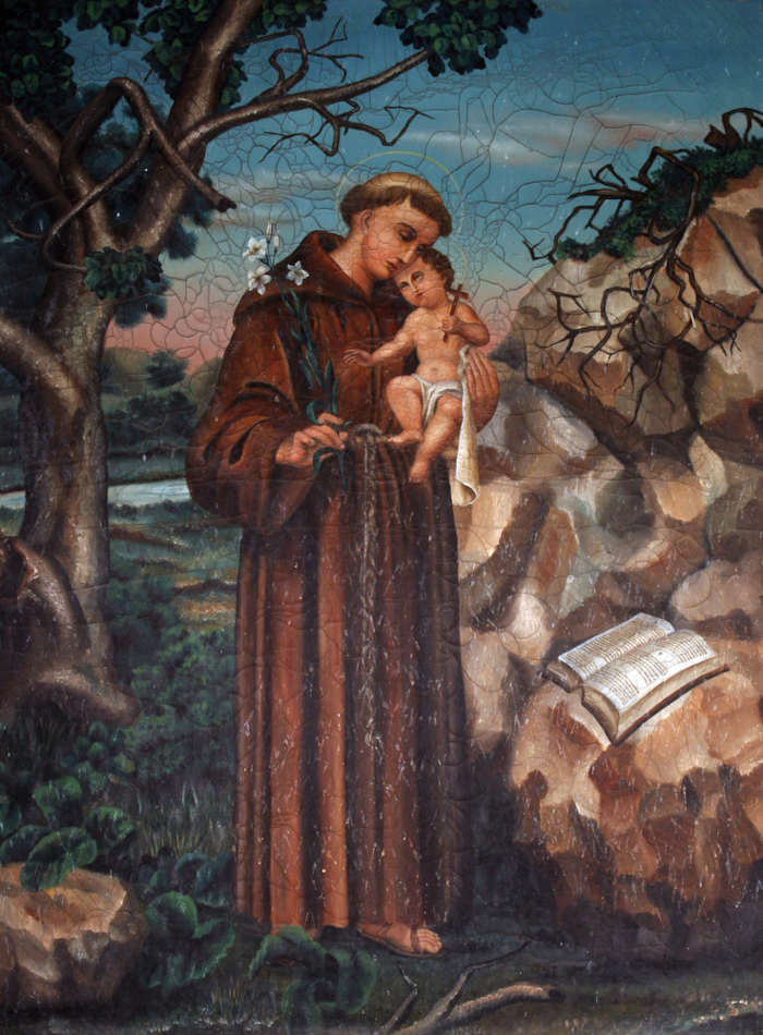 Pintura retratando Santo Antônio segurando o menino Jesus próximo a um livro, uma alusão ao Dia de Santo Antônio.