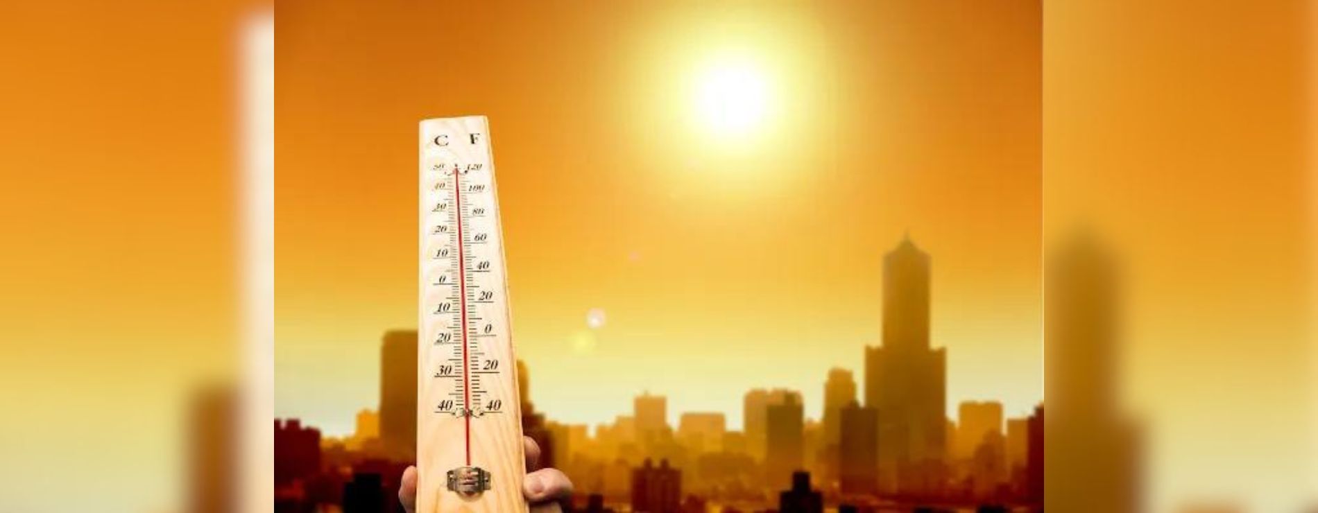 Termômetro marcando uma temperatura alta e o céu laranja